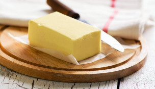 Stück Butter auf Brett